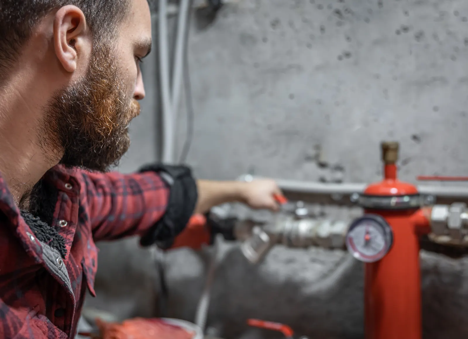Technician checking a pressure gauge and adjusting a valve during a preventative maintenance visit